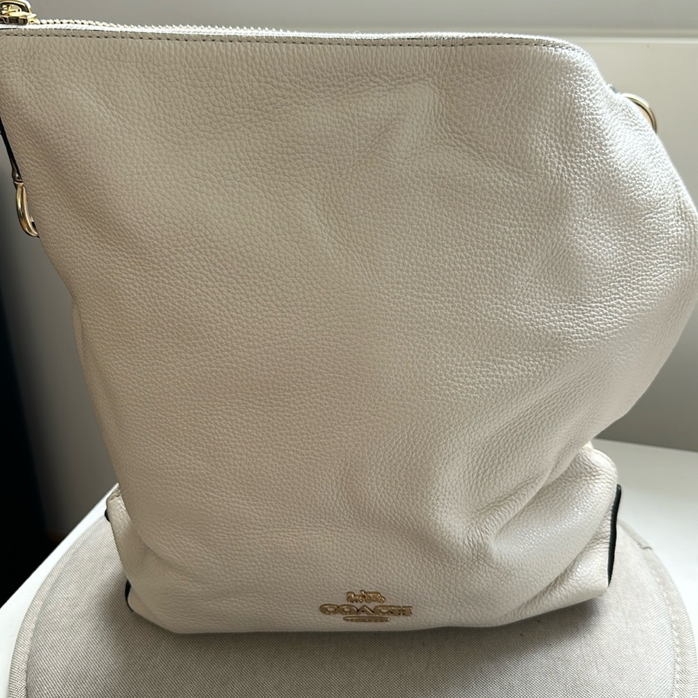 Crossbody winter white with inside and outside pockets.